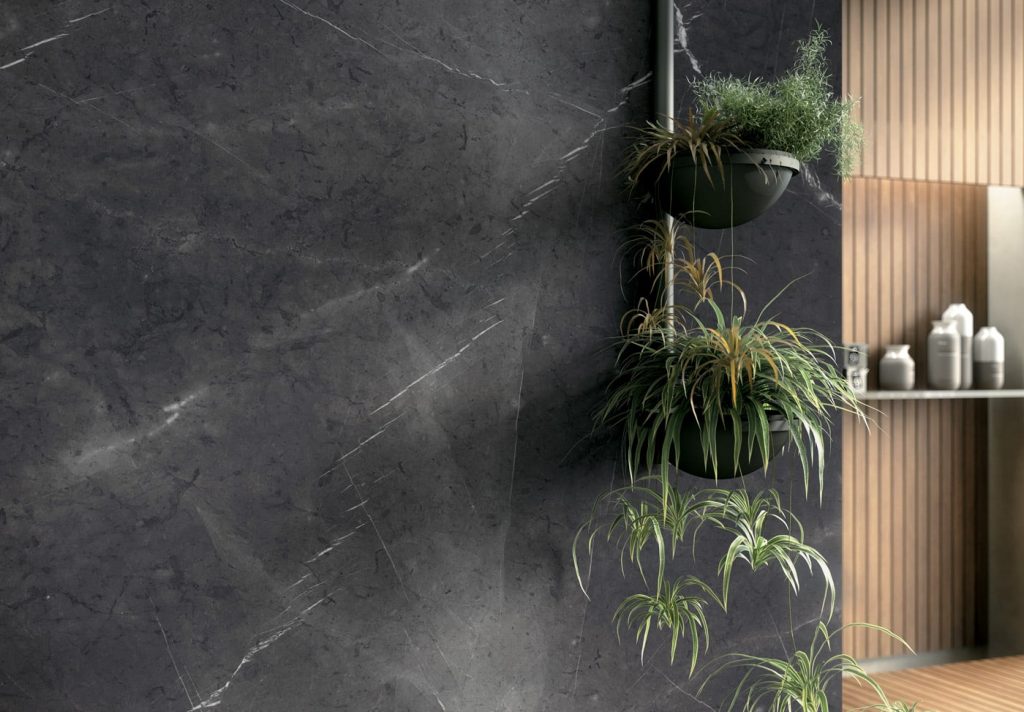 Soft, smokey black backdrop with whispery white veins that lightly flutter and dance across the surface like dragonflies atop a black lake, this porcelain slab shower surround adds a dramatic yet serene focal wall in this master bath suite.